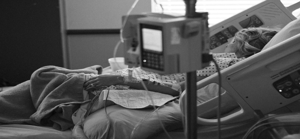 A person lying in a hospital bed